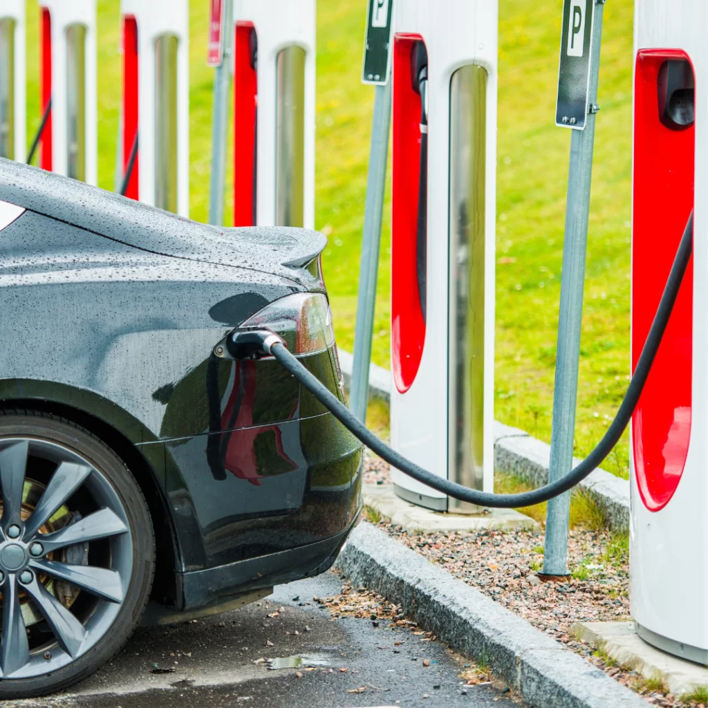 Car charging at a line of EV charging stations.