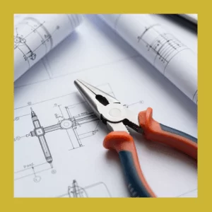 Architectural blueprints for a new home build featuring electrical symbols, pliers, and wiring plans.